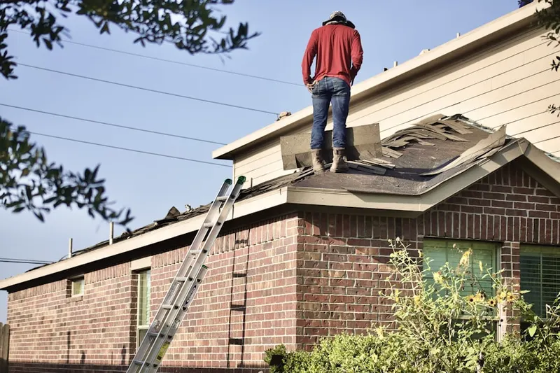 Professional roofer working on a residential roof in Winningham Farm